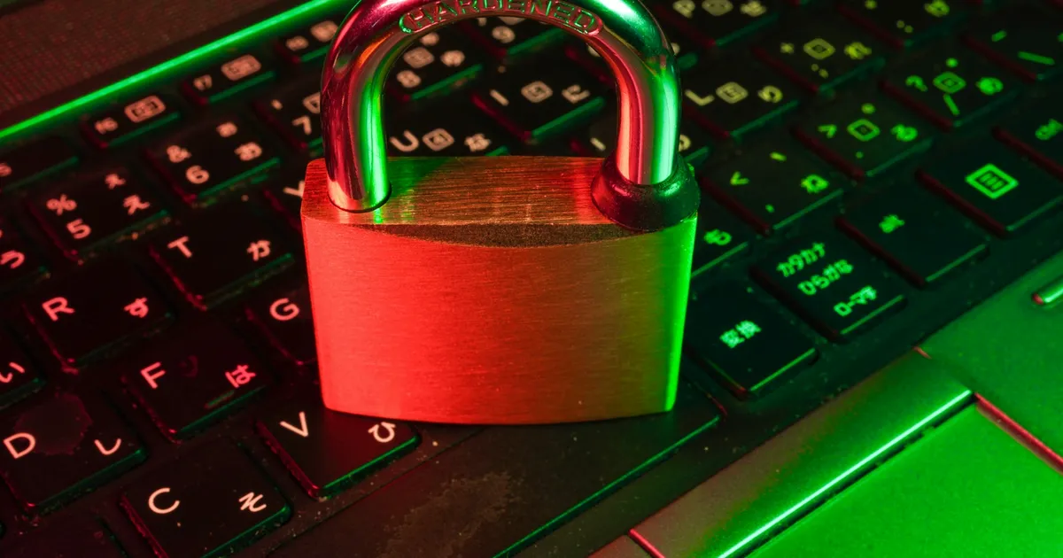Red padlock resting on a laptop keyboard, representing a VPN — ViviMate VPN guide